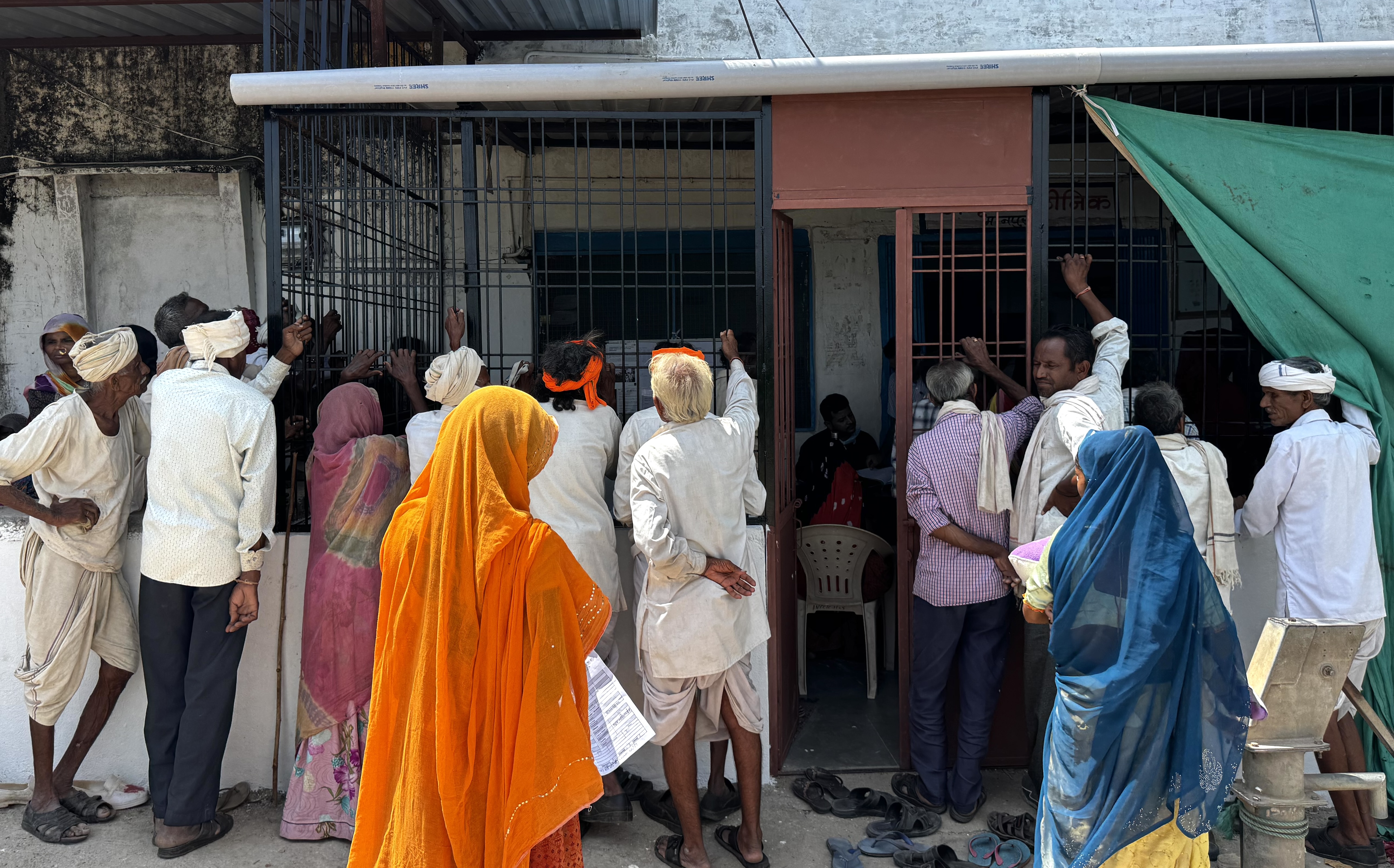 People standing and waiting outside a clinic entrance